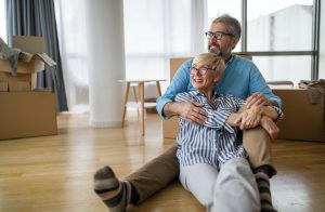 Happy retired senior couple moving into a new home, apartment